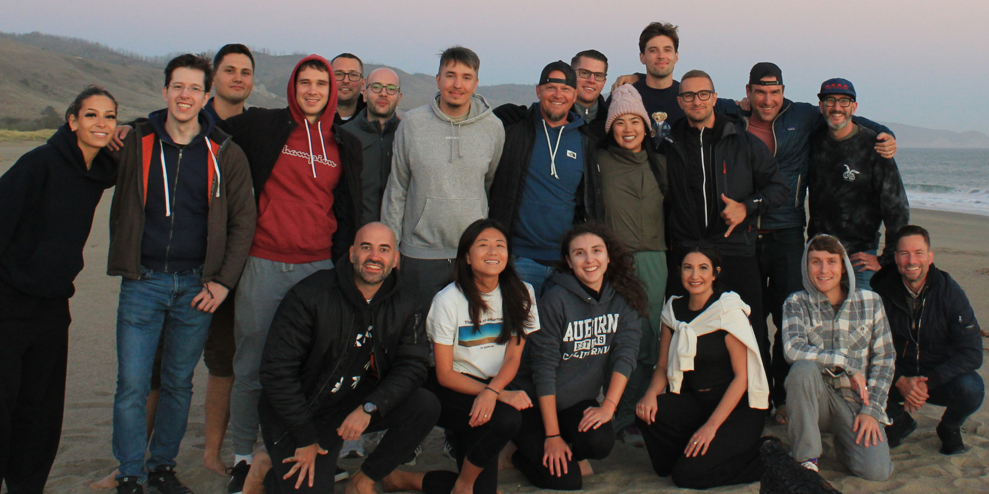 The Shovels team on the beach at dusk