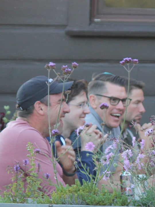 Teammates laughing together on the lodge patio