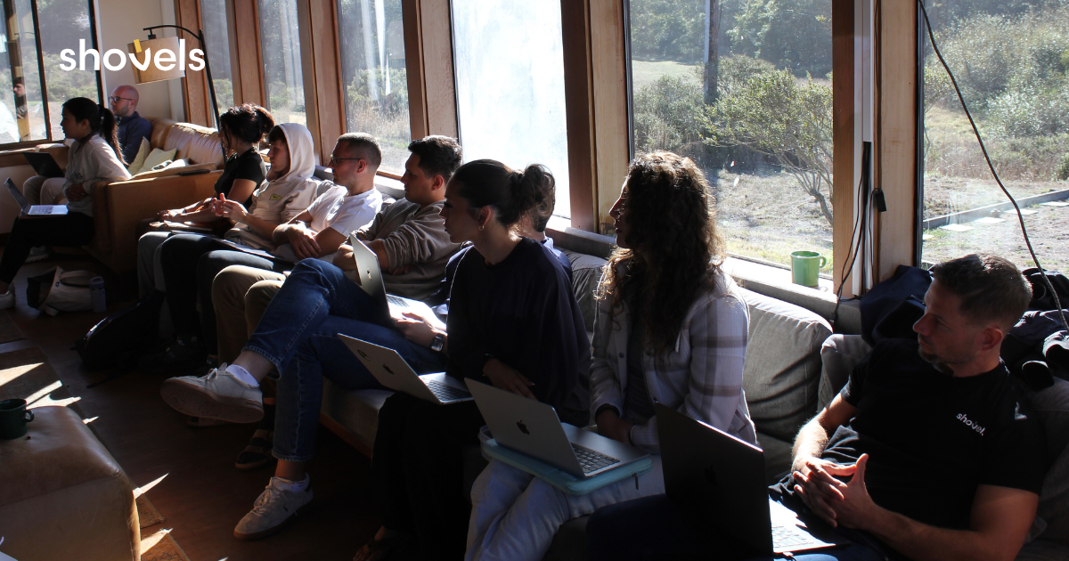 The Shovels team working on laptops along the lodge windows during the hackathon